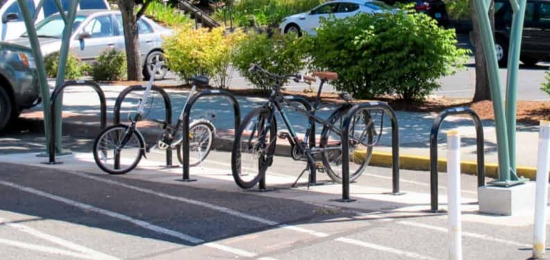 A row of bicycles parked at an inverted-U bike rack